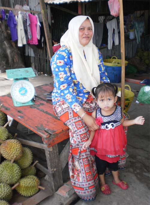 mother and daughter selling durian at the sihanoukville, cambodia port