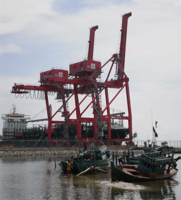 crane unloading ships at the sihanoukville port, cambodia